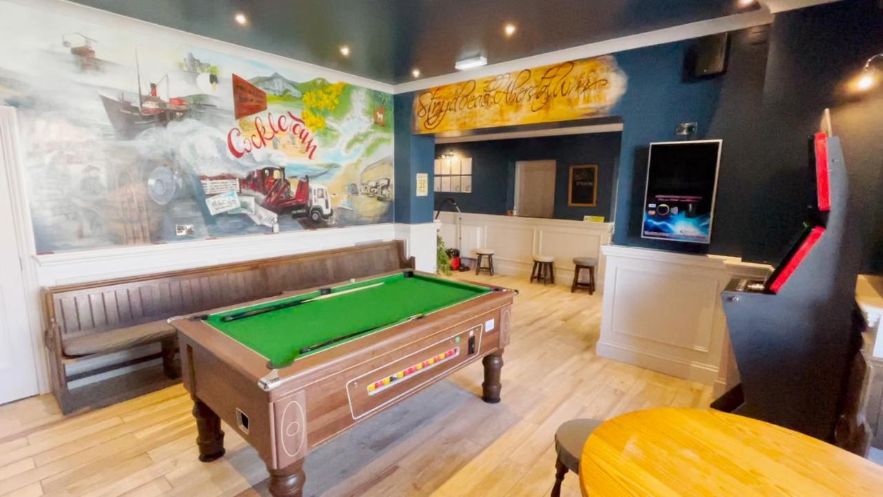 The games room: pool table under the painted murals