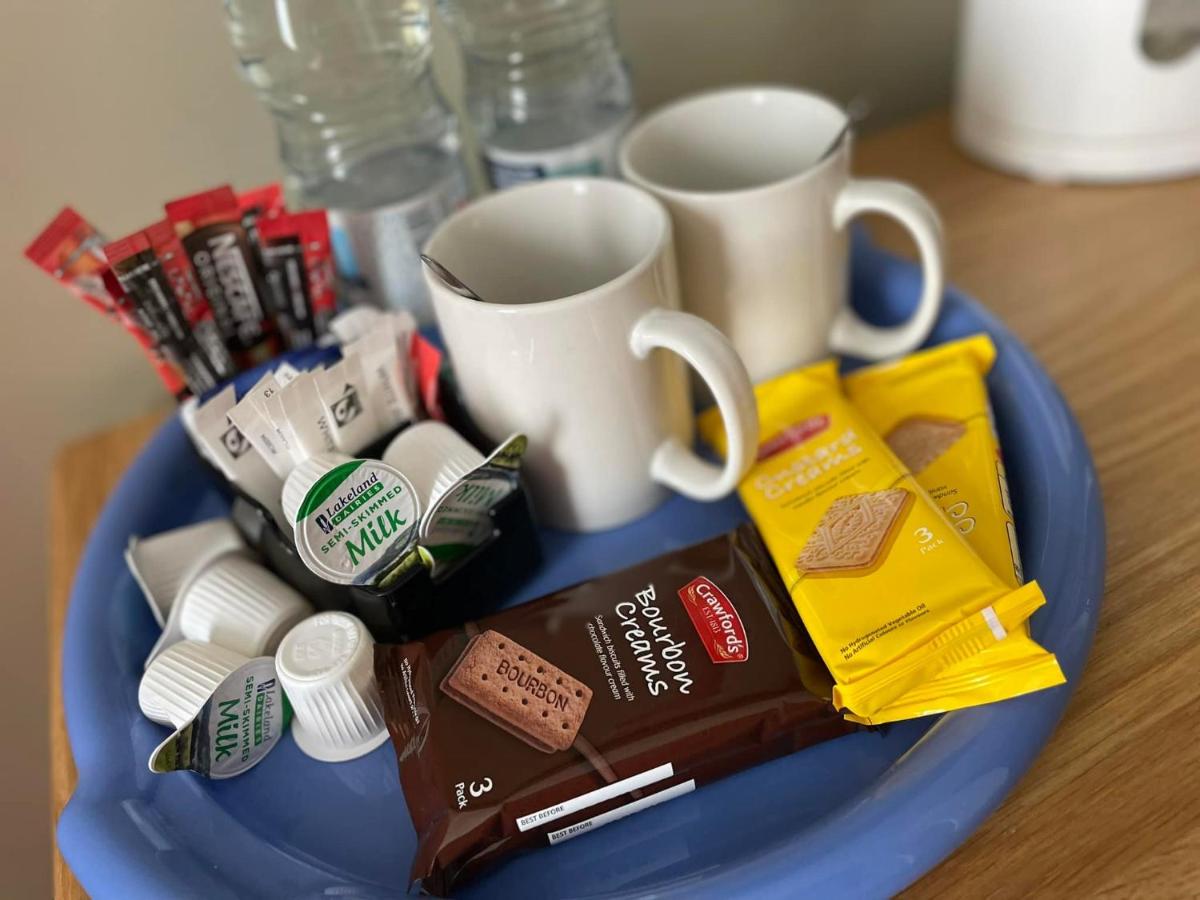 The tea tray: mugs, kettle, biscuits and snacks